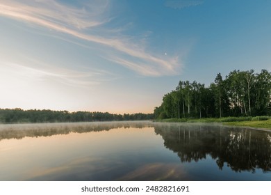 Small forest lake covered with fog at sunrise on June morning - Powered by Shutterstock