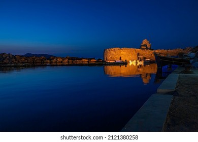 The small fortress at the Greek islands' village of Naousa, Paros island, Cyclades, illuminated at the blue hour