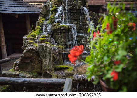 A small fountain in the backyard of a stone, an element of landscape design