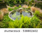 Small fountain in the Rookery in Streatham Common Park in London, UK