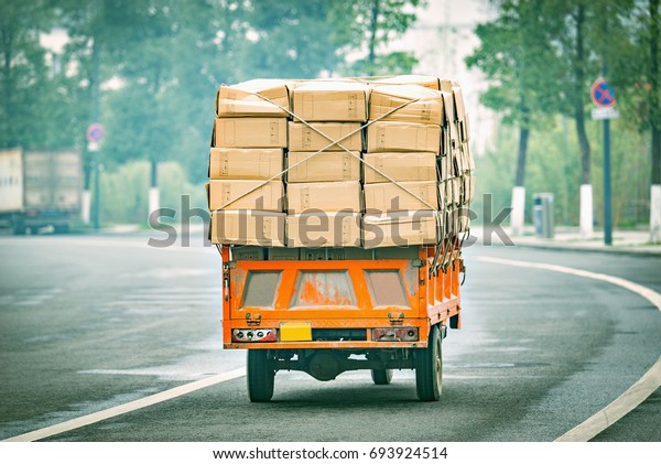 Small freight\
car with cardboard boxes.\
China.