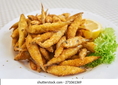 Small fried fish, A small dish of fried whitebait with slices of lemon. This would be served as a starter or tapas in Spain.