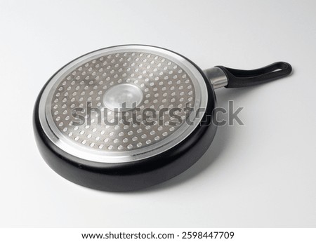 Small frying pan reverse side isolated, steel bottom of new non stick mini griddle, induction cookware, single egg pan, little griddle or fryingpan on white background