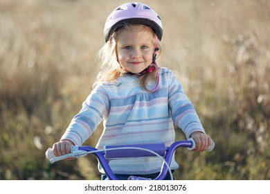 Small Funny Kid Riding Bike With Training Wheels.