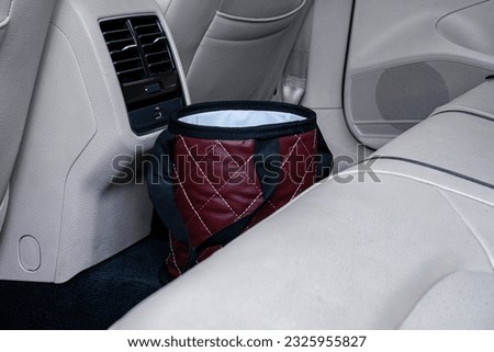 small garbage bin in car different color  