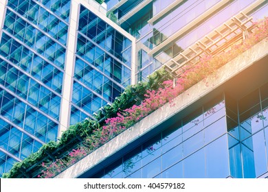 Small Garden Of Flowers In Front Of Office Building.