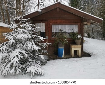 A Small Garden Shed In Winter With Snow.