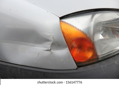 Small Generic Car With Dented Front Wing. Minor Accident Result - Fender Bender.