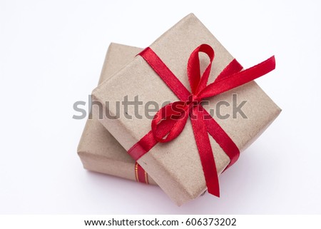 Small gift box with red ribbon on white background