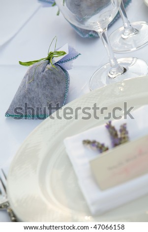 Small gift on table with a wine glass and plate