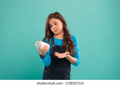 Small Girl Hold Medicine Jar. How To Act While Pandemic Of Covid-19. Omega And Calcium. Child Going To Take Vitamin. Useful Food Additives. Pills For Kids. Healthy Vitamin Complex.