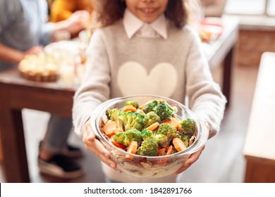 Small Girl Holding Vegan Healthy Dish With Various Vegetables For Family Holiday Dinner, Selective Focus. Christmas, New Year, Thanksgiving, Anniversary, Hanukkah, Mothers Day, Easter Concept