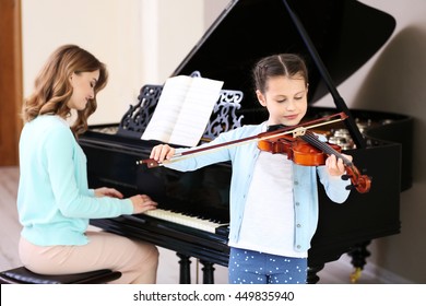 Small Girl Learning Play Violin With Teacher