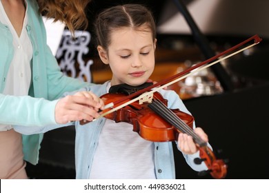 Small Girl Learning Play Violin With Teacher