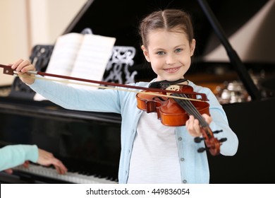 Small Girl Learning Play Violin With Teacher