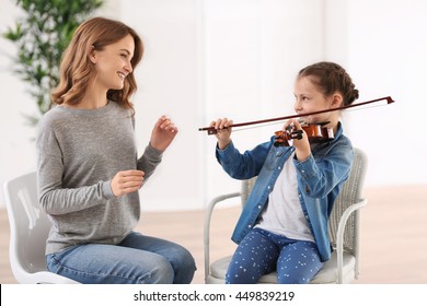 Small Girl Learning Play Violin With Teacher