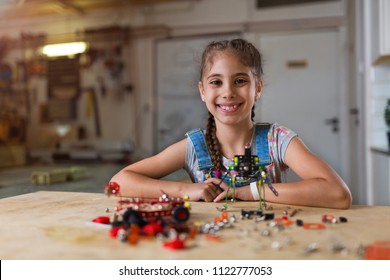 Small Girl Making A Robot