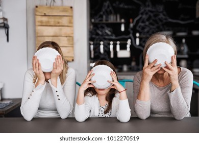 A small girl with mother and grandmother at home. - Powered by Shutterstock