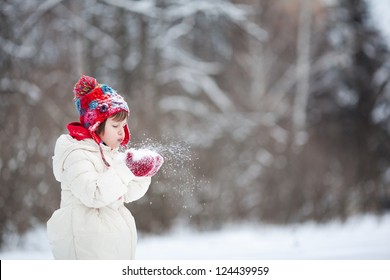 Small Girl Playing With Snow