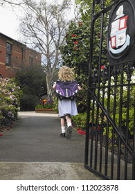 Small Girl Running Out Of The School Gate