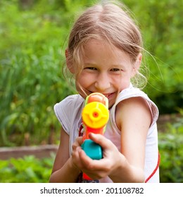 Small Girl Shooting From Funny Toy Water Gun