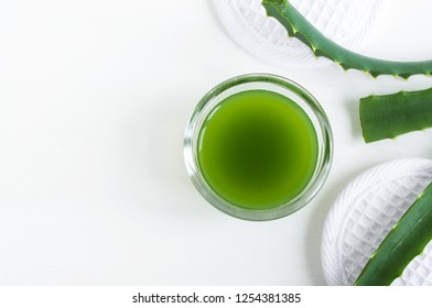 Small glass bowl with aloe vera juice. Homemade facial toner or hair mask (moisturizer). Natural beauty treaments and spa. White background. Top view, copy space.  
