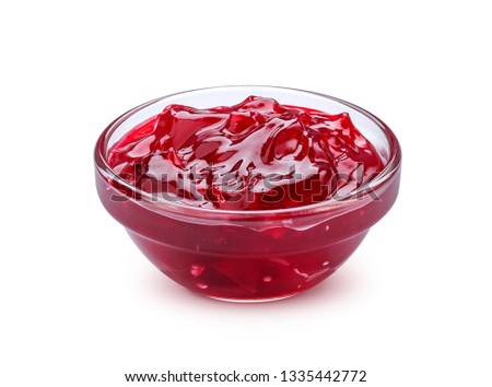 Small glass bowl of red berry jam isolated on white background, sweet cherry jam
