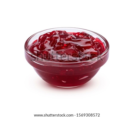 Small glass bowl of red berry jam isolated on white background with clipping path