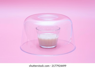 Small Glass Of Milk Inside A Clear Glass Dome