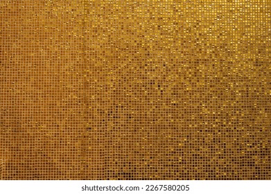 Small gold tile texture. Small golden tiles arranged to fit it into background. Shiny golden mosaic background with small square, glazed tiles in rows - Powered by Shutterstock