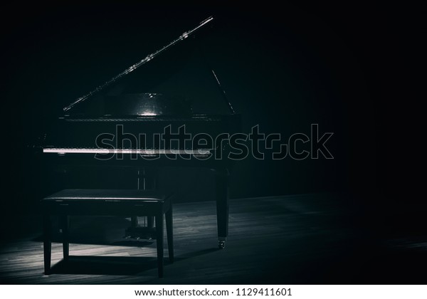 small grand piano\
in dark room vintage\
style