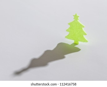 Small Green Christmas Tree With Long Shadow On White Background