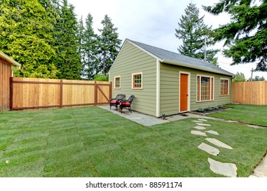 Small Green Guest House In The Fenced Back Yard.