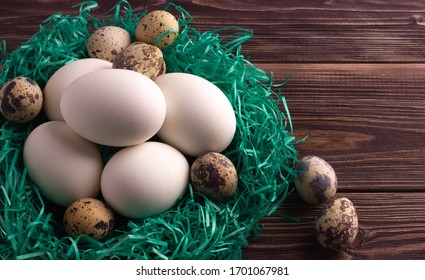 Small Green Nest With Chicken And Quail Eco Eggs On The Dark Wooden Background. No People.