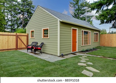 Small Green And Orange Guest House In The Back Yard