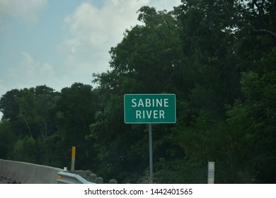 Small Green Sabine River Sign With White Lettering.