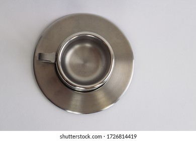 Small grey steel coffee cup and saucer  with white background. A view from the top to coffee pair.  Copy space . - Shutterstock ID 1726814419