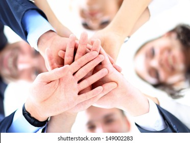 Small Group Of Business People Joining Hands, Low Angle View.