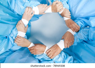 Small Group Of Doctor Team Joining Hands, Bird's Eyes Angle View.