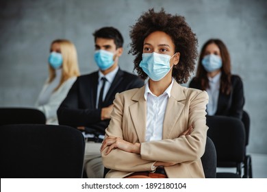 Small Group Multiracial Of Business People With Face Masks Sitting On Seminar During Corona Virus. Selective Focus On Mixed Race Woman In Foreground.