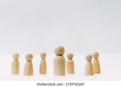 Small group of separated people seen from above represented anonymous with wooden figures on white background. - Shutterstock ID 1729762267