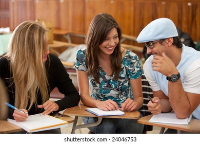 Small Group Of Students Sitting In A Classroom Smiling