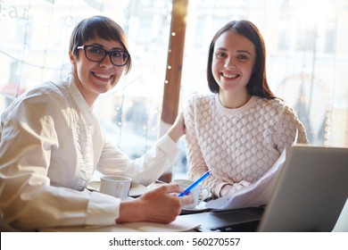 Small Group Of Successful Businesswomen Having Meeting Or Appointment In Cafe