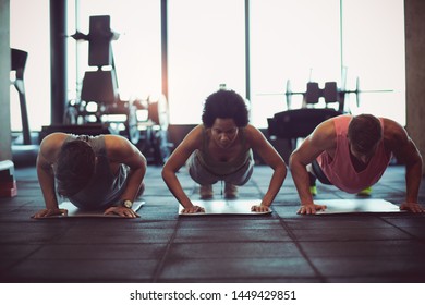 Small Group Training. People At Gym.