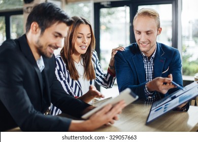 Small Group Of Young People At A Business Meeting In A Cafe. Selective Focus On Woman And Blonde Man.