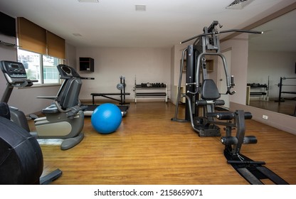 A Small Gym Room With Several Expensive Equipments For Training