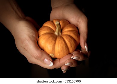 Small Halloweenpumpkin on a hand