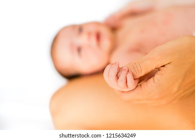 Small hands and fingers of newborn baby.