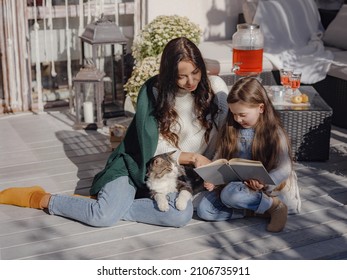 Small Happy Family Celebrating Thanksgiving. Cute Funny Toddler And Cat. Harvesting Gifts Autumn. Countryside Lifestyle. Parenthood Small Moments, Read Interesting Book