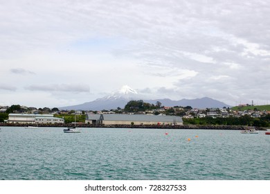 small harbor in front of a mountain   